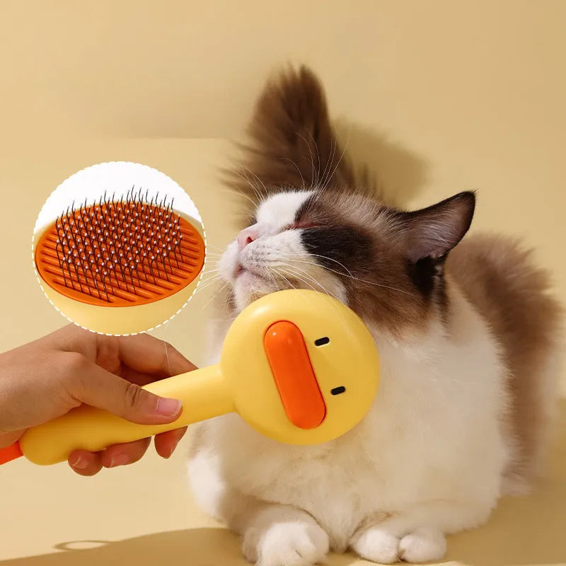 Small yellow duck-shaped pet grooming comb with needle teeth for cat and dog hair removal