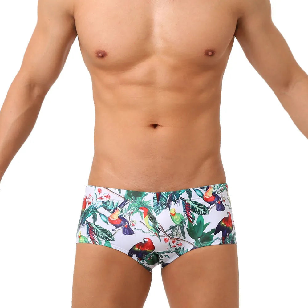 Men's floral bird print swimming trunks in nylon fabric, shown in small boxer style.