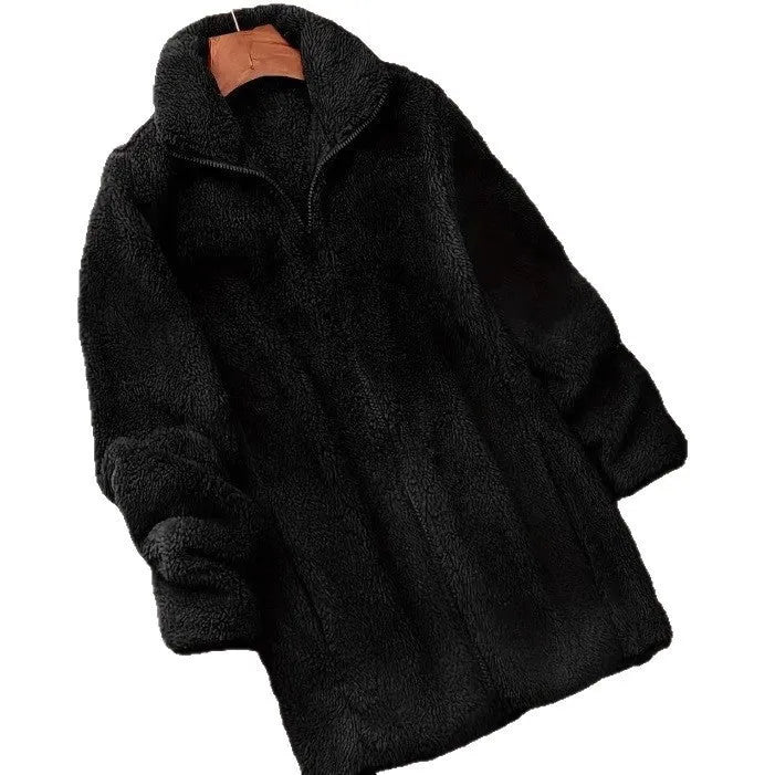 Man wearing a double-sided black fleece jacket with a velvet texture.