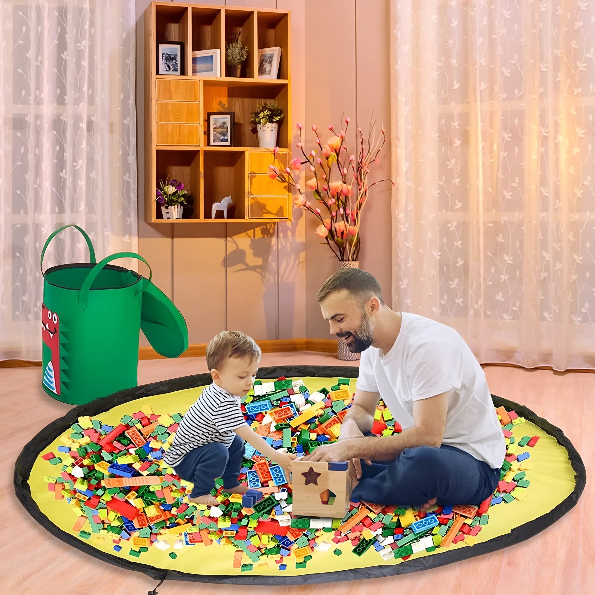 Green felt cube storage bag with pull rope open as a floor play mat for toys.