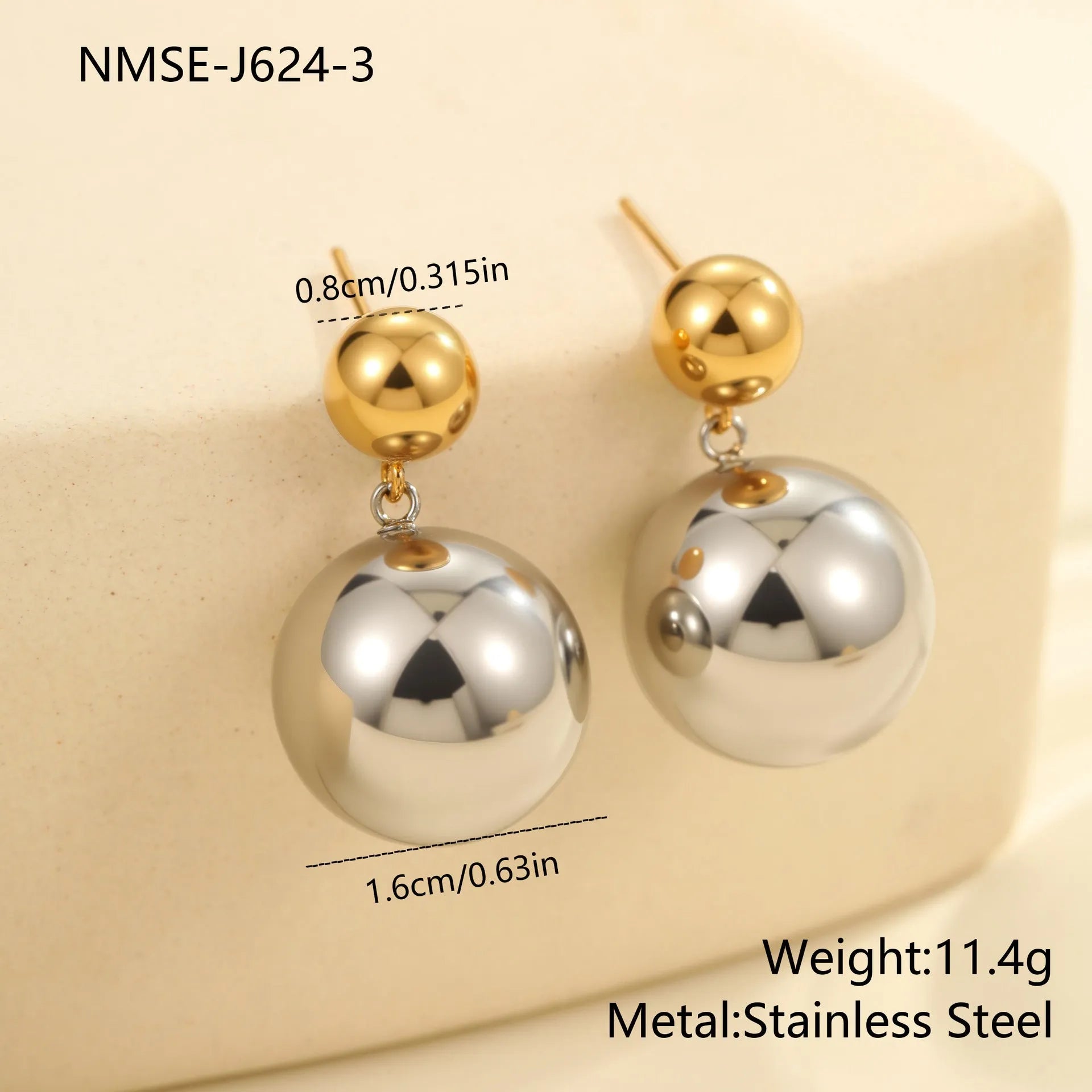 A pair of geometric round bead ear studs with a colour-block finish on stainless steel.