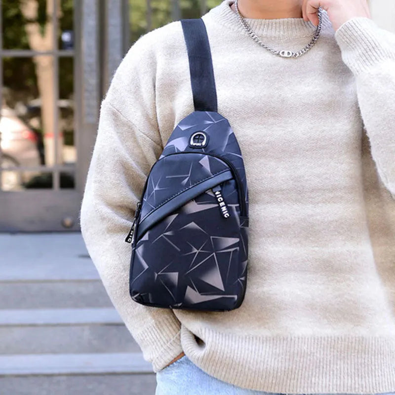 Men's black print sling chest bag with earphone hole and zipper, showing inner patch pocket.