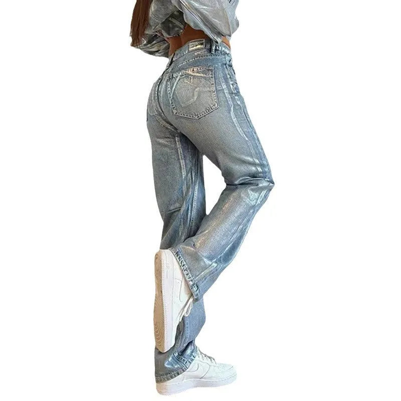 Blue high waist straight-leg denim jeans with contrast details on a neutral background.