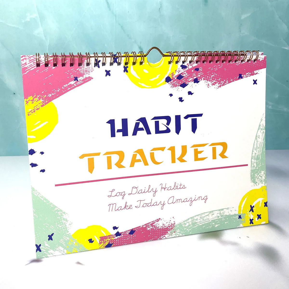 A4 habit tracking planner showing pink white cover with 12 internal pages for schedule recording