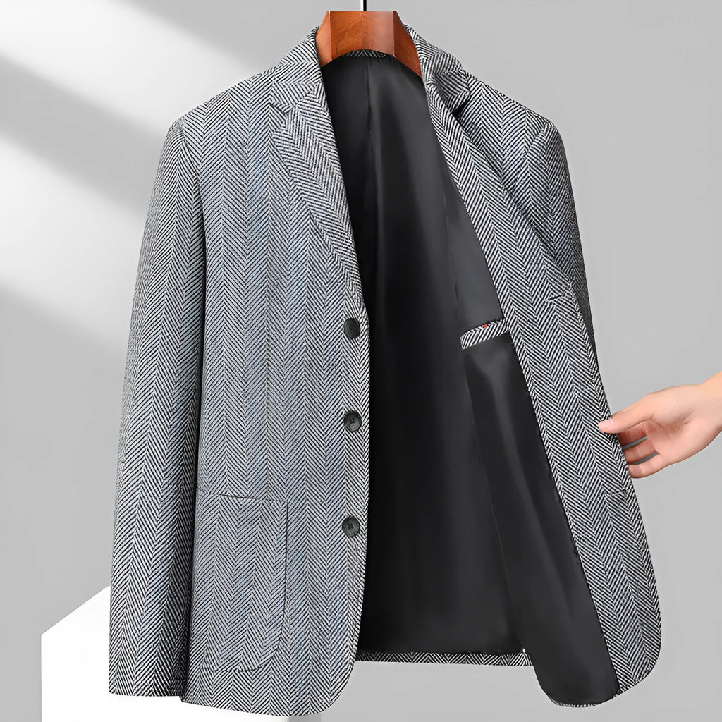 A man wearing a solid colour loose-fit wool blend coat suitable for spring or autumn.