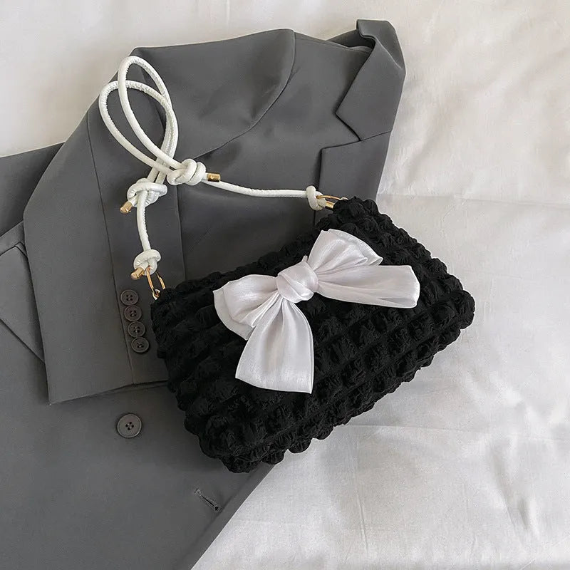 Women's casual canvas handbag with single shoulder strap in black, white, or pink colours showing sandwich pocket design