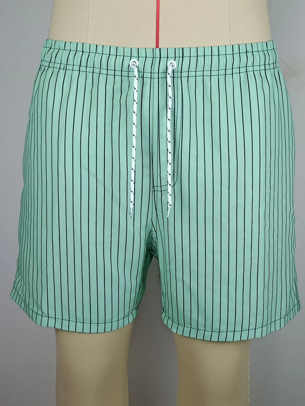 Polyester fibre striped beach shorts in navy blue with straight leg opening