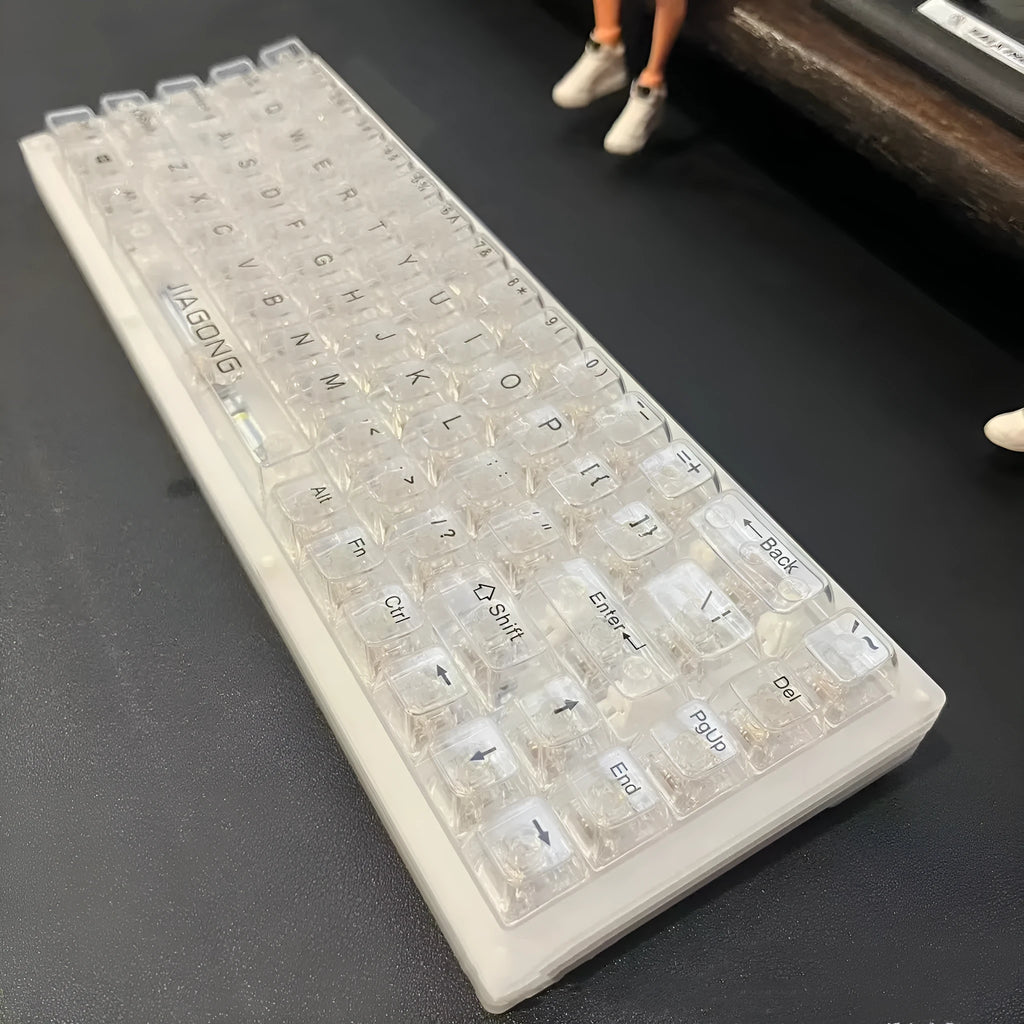 Full set of 132 transparent plastic key caps for mechanical keyboards laid out.