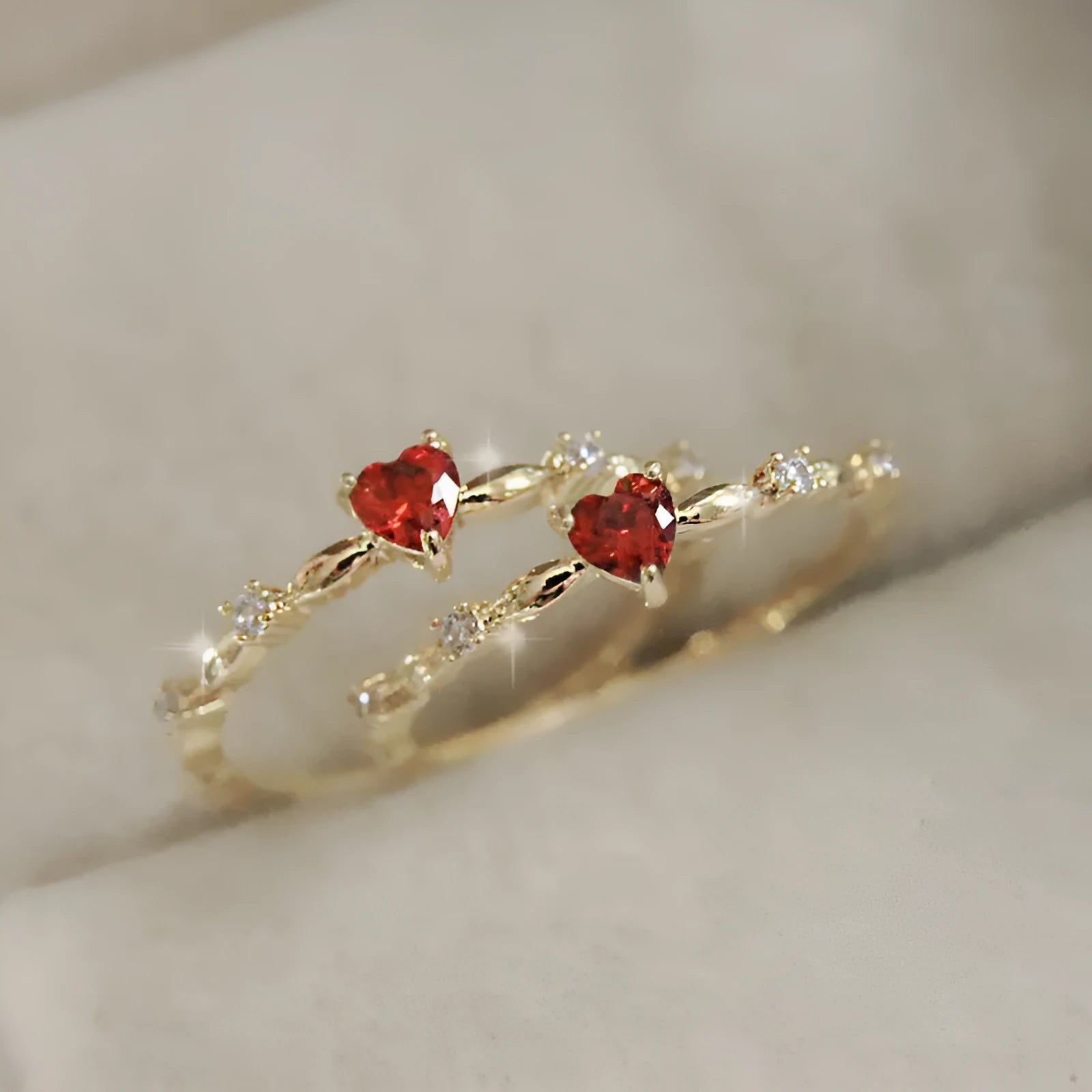 Gold or silver colour peach heart shaped ring with zircon stones on a copper band.