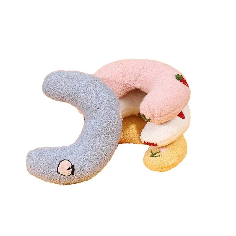 Blue half moon U-shaped cloth pillow for pets in a crate.