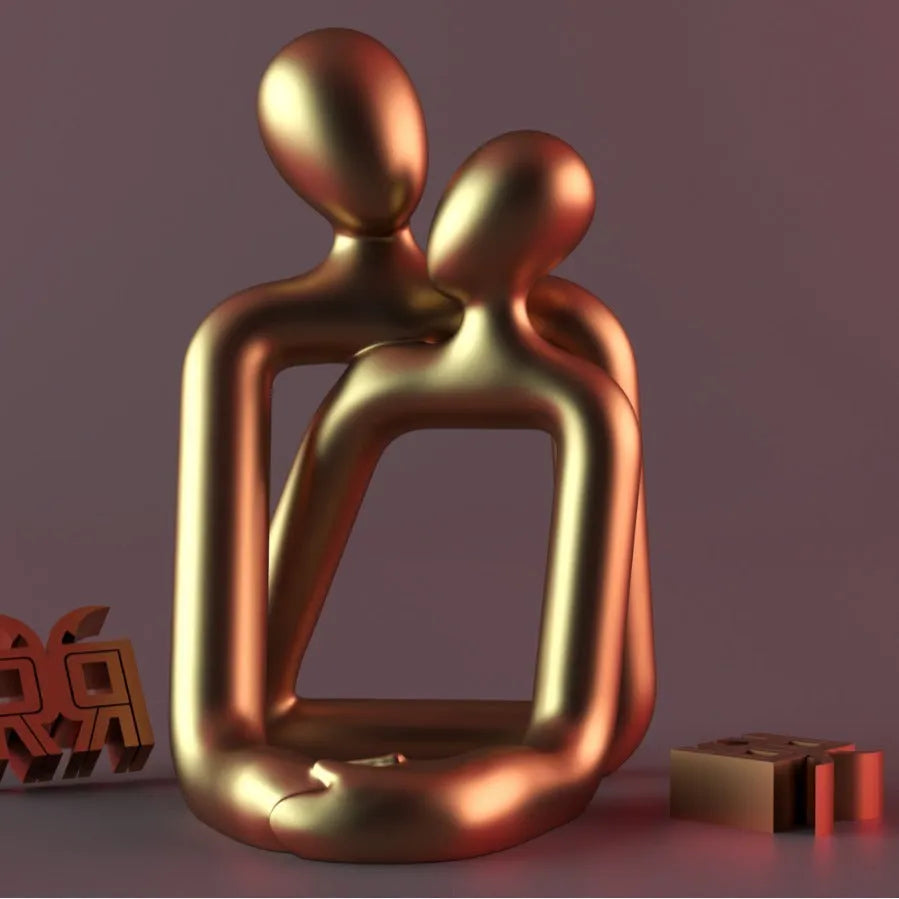 Modern couple resin statue in milky white or gold colour on a desk or shelf