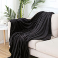 Solid colour polyester flannel blanket in big red, lying flat on a surface