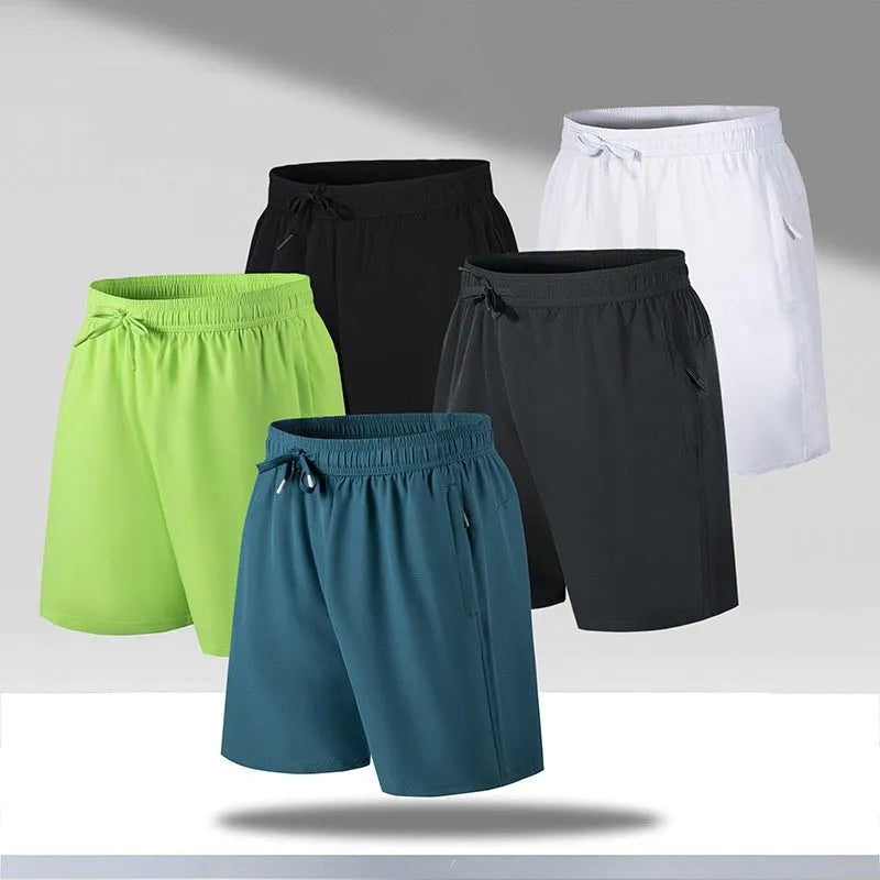 Man wearing loose fit black quick-dry ice silk sports shorts on a beach.