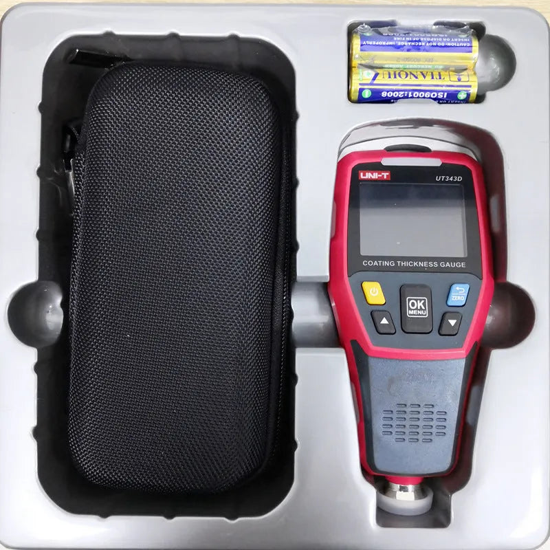 Coating thickness gauge with digital display showing measurement value on a surface