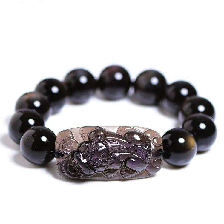 Polished icy obsidian crystal Pi Xiu bracelet with geometric ethnic style on adjustable cord.