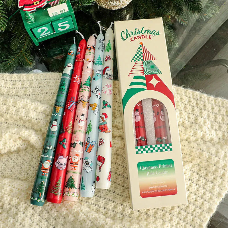 Christmas printed paraffin cylinder candle in bright red, 2.2x25cm, on a table