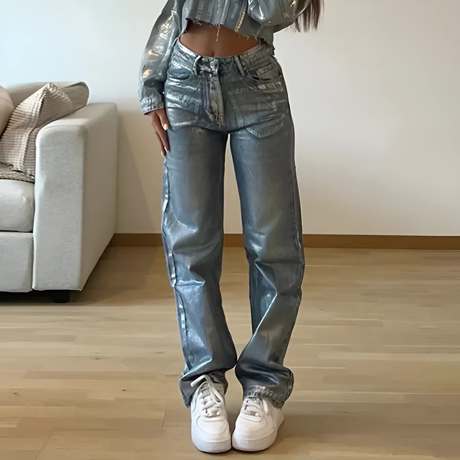 Blue high waist straight-leg denim jeans with contrast details on a neutral background.