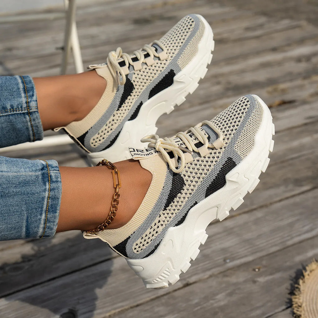 Women's Flyknit mesh lace-up sneakers in a selection of colours, showing round toe and flat rubber sole.