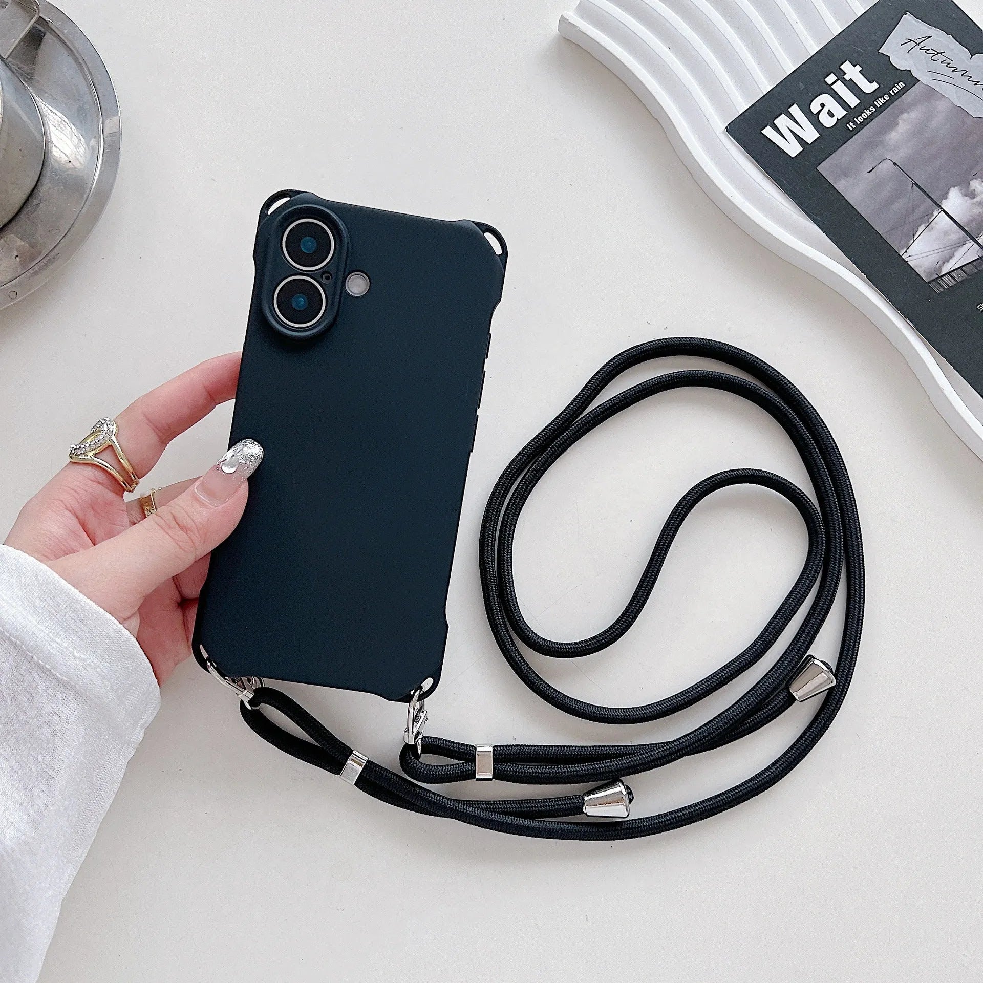 Four-corner cross lanyard liquid silicone phone case for Apple iPhone 16 in antique white with matching lanyard