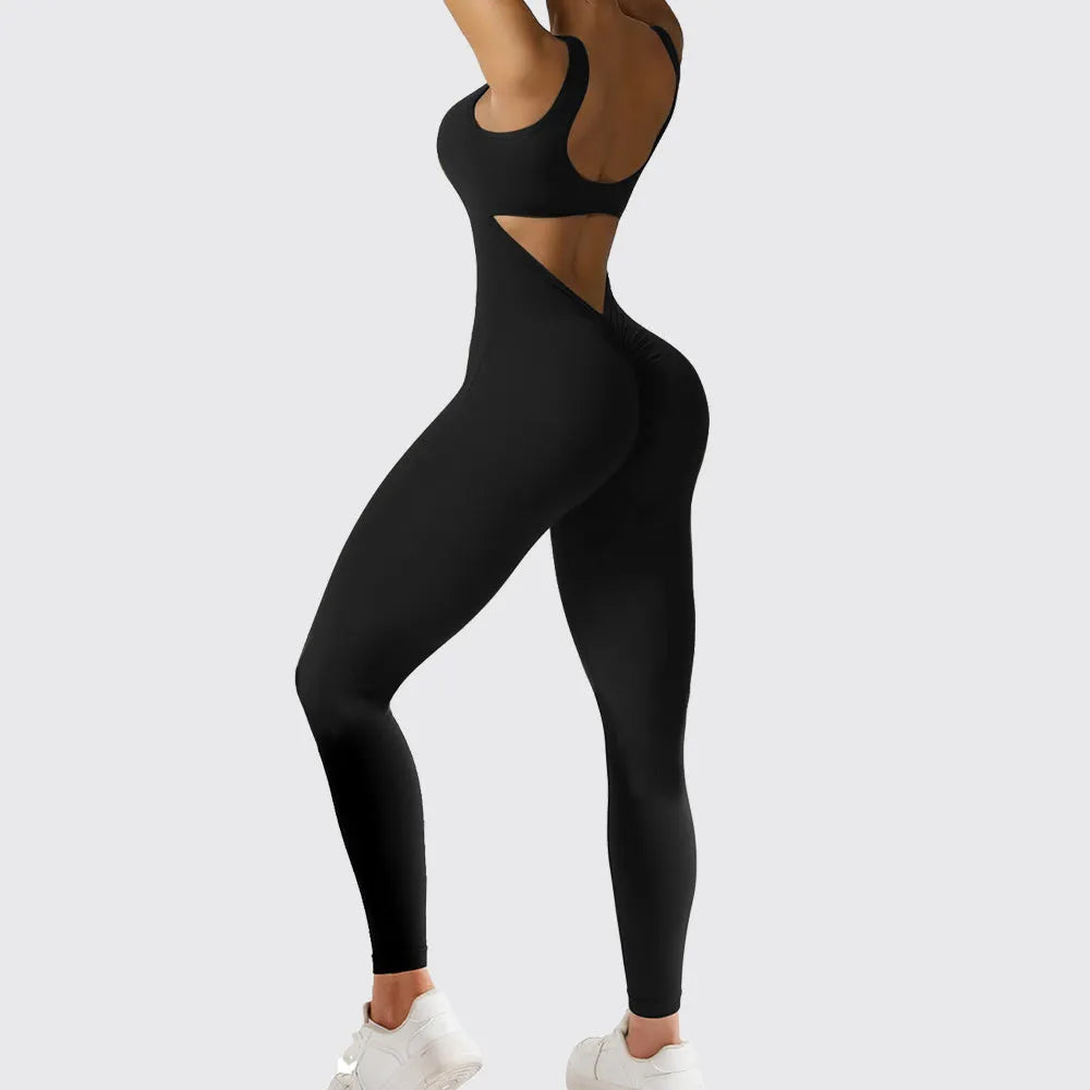 Woman wearing a sleeveless army green flare jumpsuit for yoga, demonstrating the high-elasticity polyester fabric.