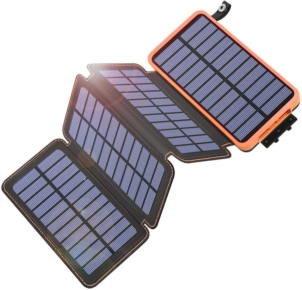 Black solar power bank with a solar panel, LED light, and soft leather exterior, shown outdoors.