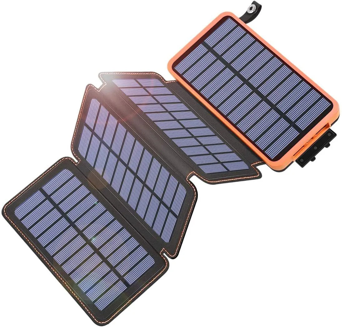 Black solar power bank with a solar panel, LED light, and soft leather exterior, shown outdoors.