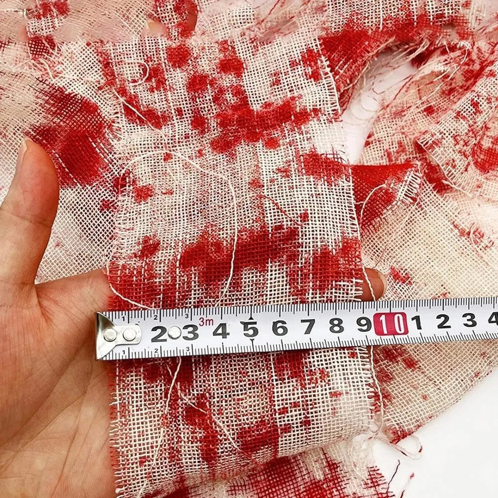 Roll of red polyester horror bandage with bloody print for Halloween decorations and costumes.