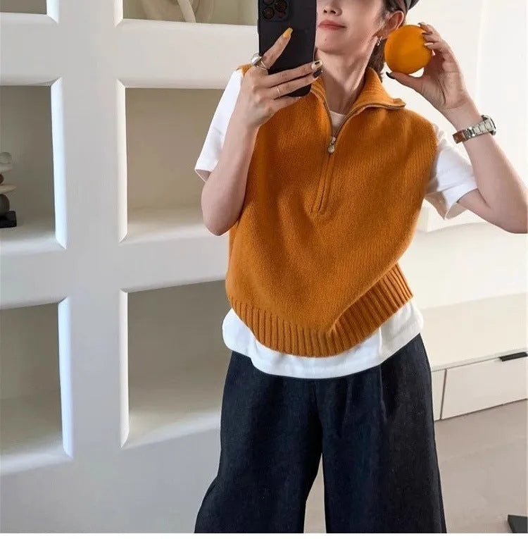 Women's half-zip sleeveless knit vest in mesh fabric with a 3D pattern, shown in orange colour.