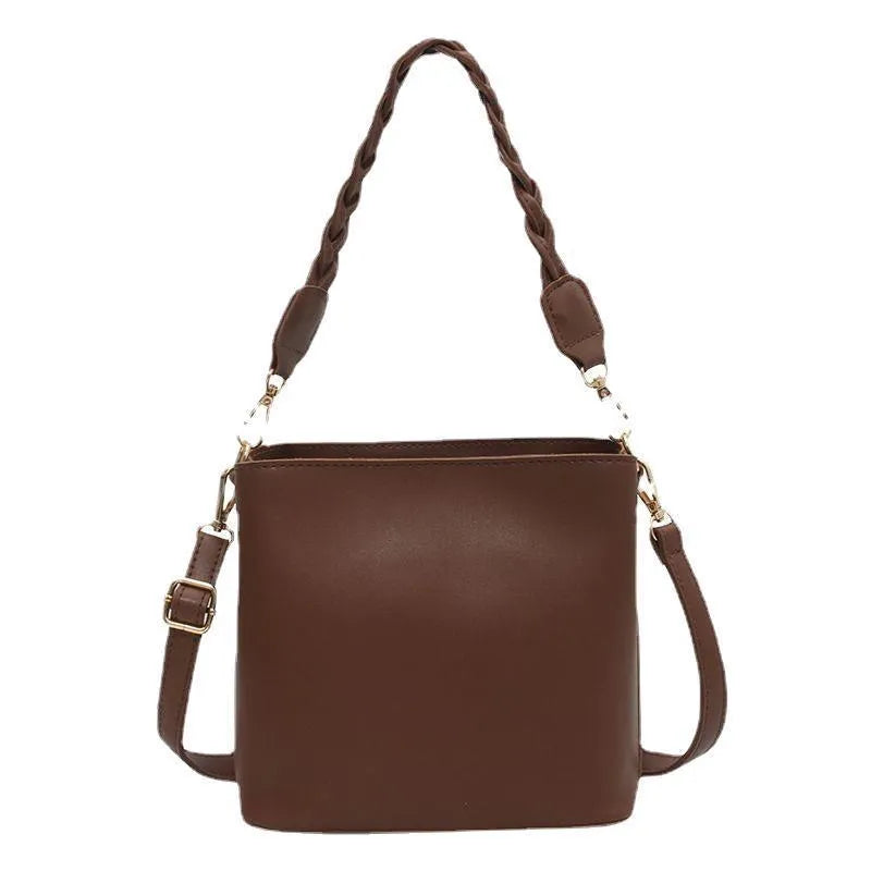 Unisex khaki PU leather crossbody bucket bag with woven texture and one shoulder strap.