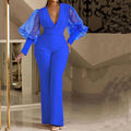 Women's red mesh stitching jumpsuit with long sleeves, elastic waist, and wide-leg trousers on a model.