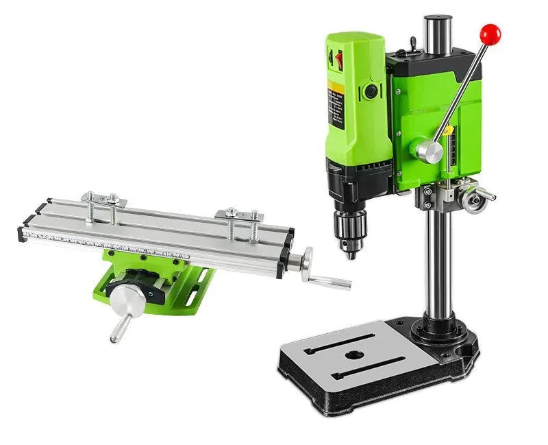 Bench drill milling machine on a workbench with cross bench pliers.