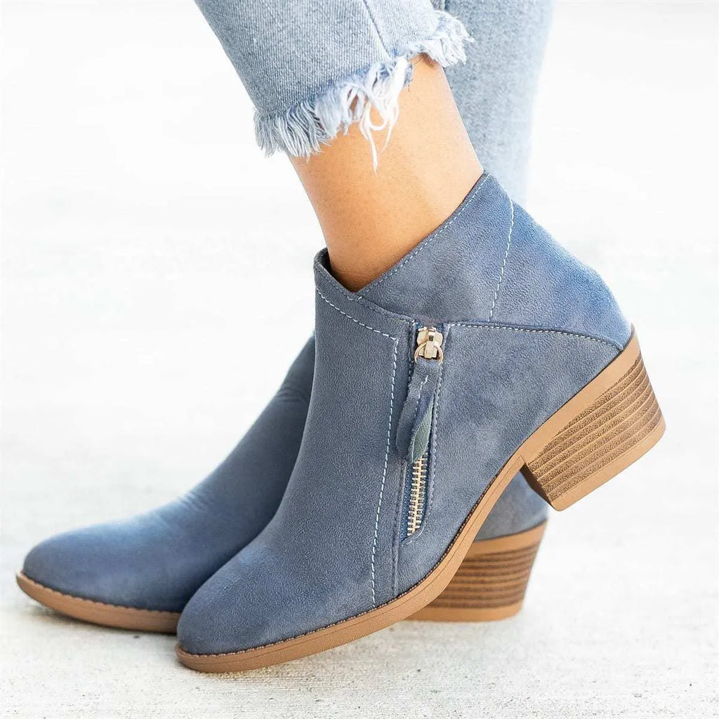Blue suede women's ankle boots with a side zip and chunky composite sole, shown from the side.