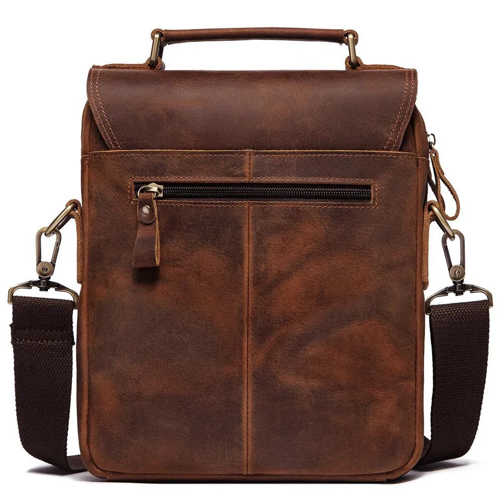 Men's brown leather shoulder bag with zipper buckle closure on soft surface