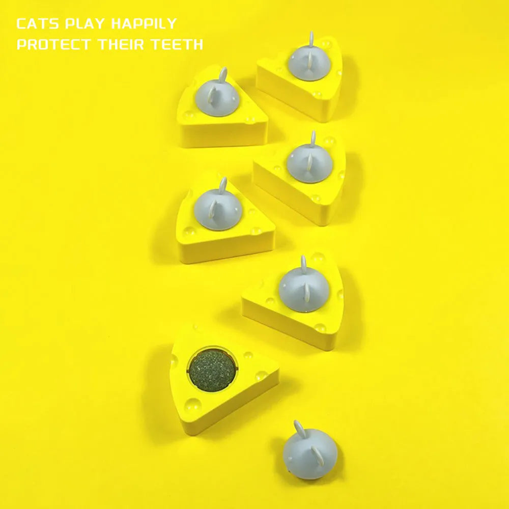 Yellow cheese-shaped cat toy ball with textured surface for teeth cleaning, filled with catnip and silvervine.