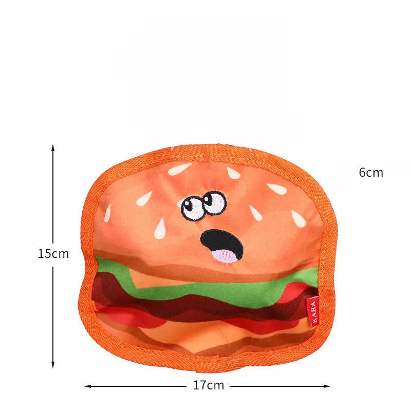 Food-themed dog chew toy in a hamburger design with red, yellow, and green colours, showcasing its no-stuffing construction.