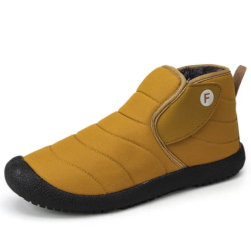 Men's black waterproof snow boot with thick sole and plush lining on a hard ground surface.