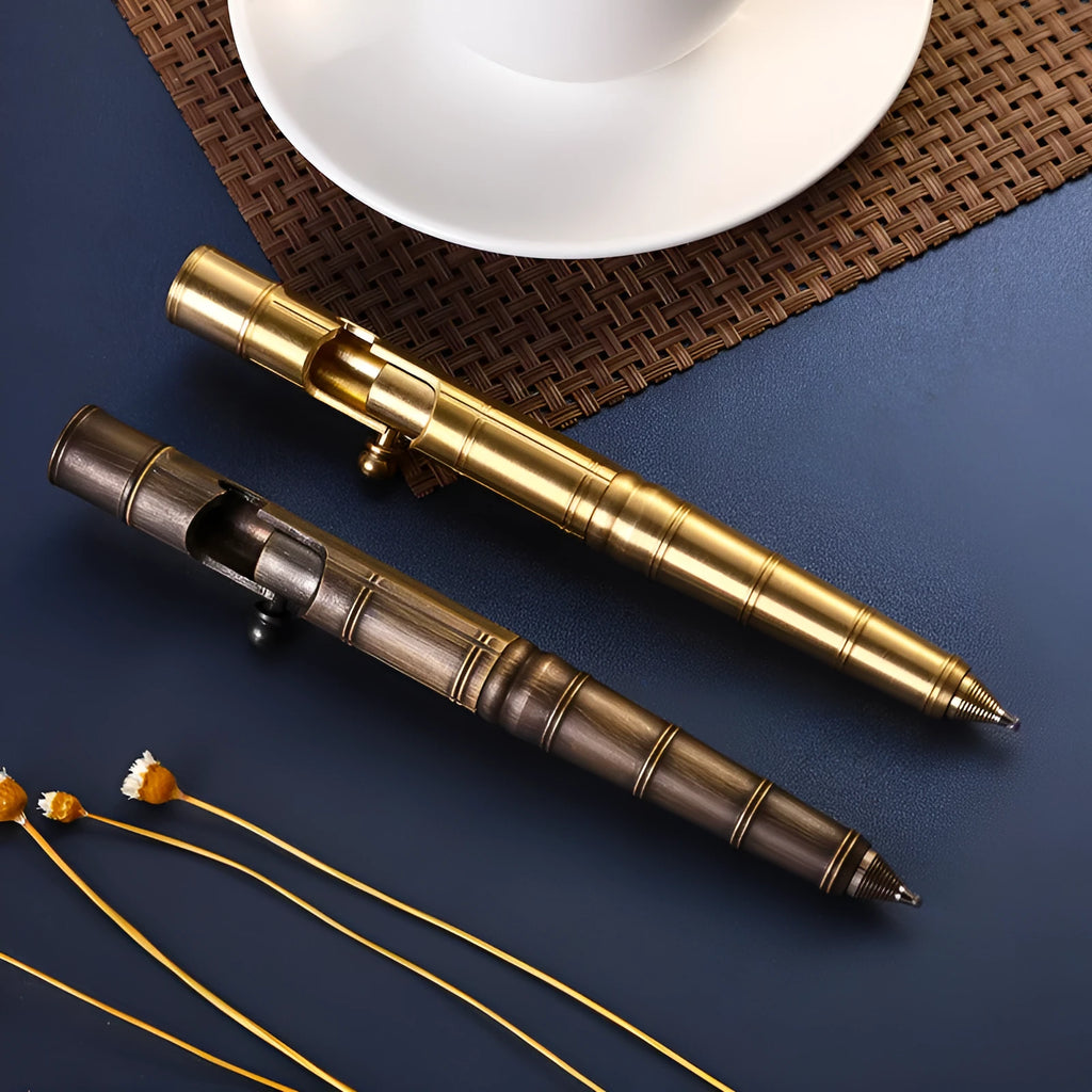 Solid brass cylindrical tactical pen with a press mechanism and six-ring detail.