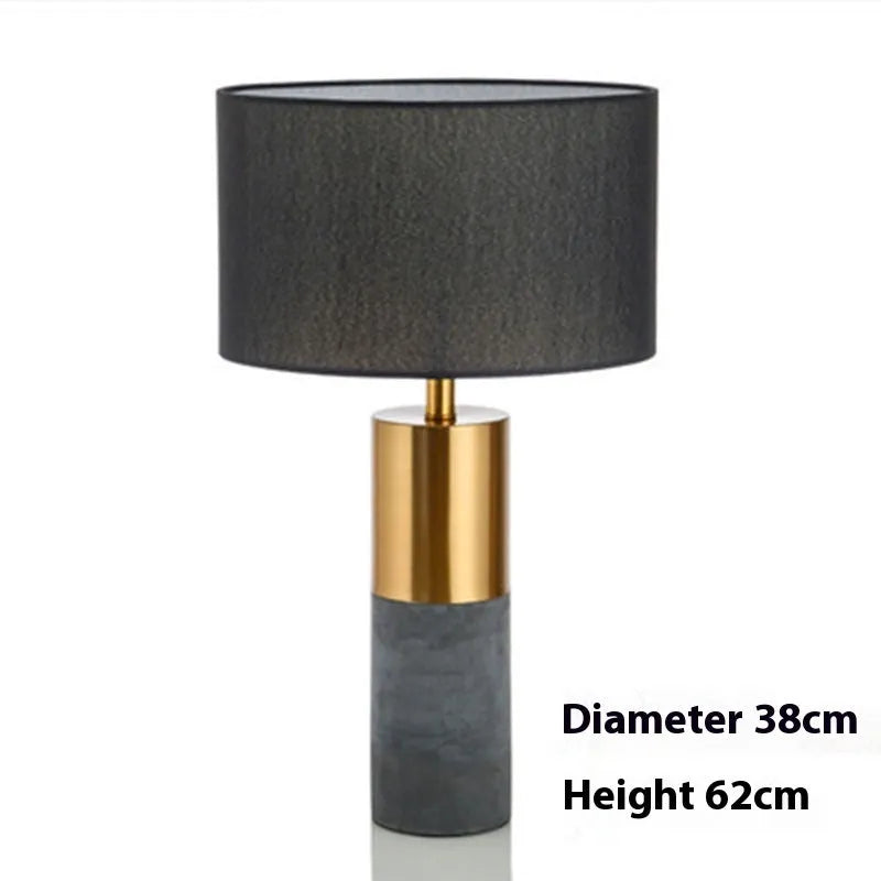 Simple designer industrial style table lamp in dark gray on a wooden desk with ambient lighting