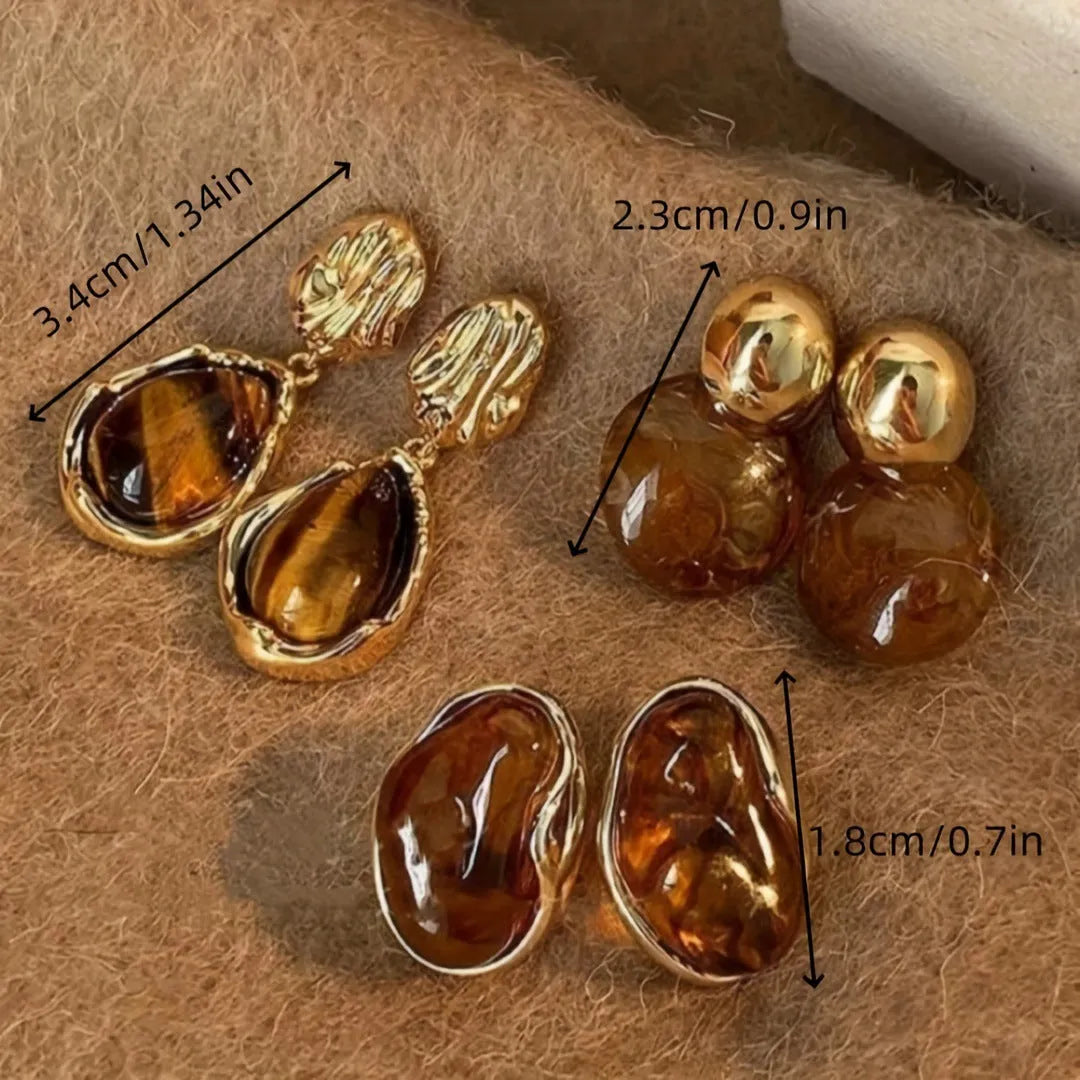 Handmade alloy earrings set showing three geometric designs: irregular amber, wafer disc and water drop tigereye styles