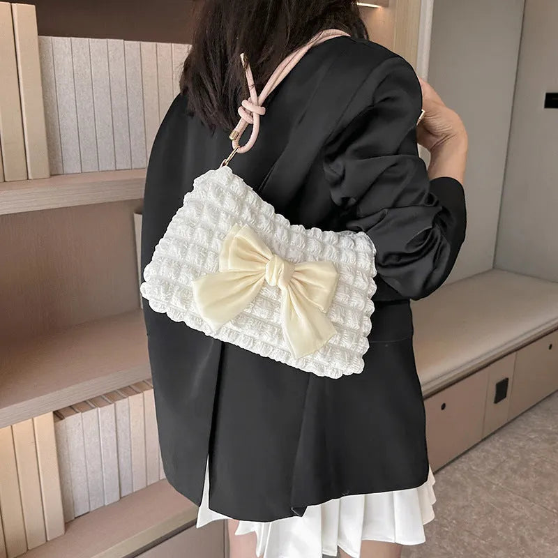 Women's casual canvas handbag with single shoulder strap in black, white, or pink colours showing sandwich pocket design