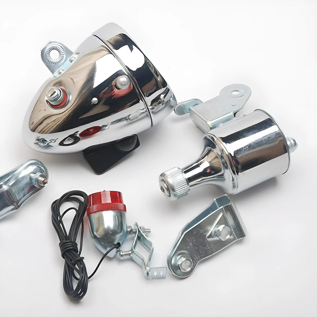 Silver aluminium bicycle dynamo light kit mounted on a bike fork for friction-powered lighting.