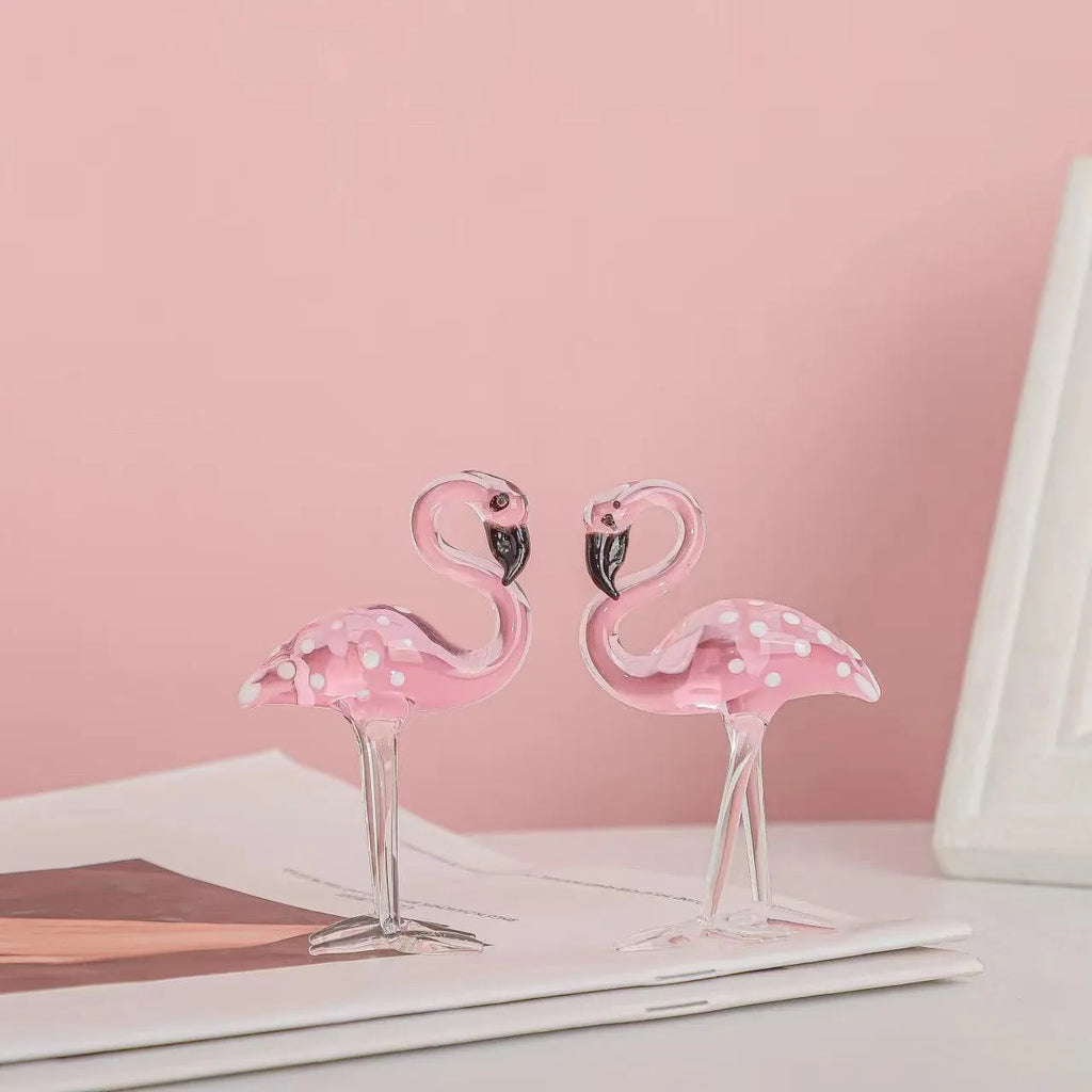 White crystal flamingo decorative ornaments with pink dots on a table
