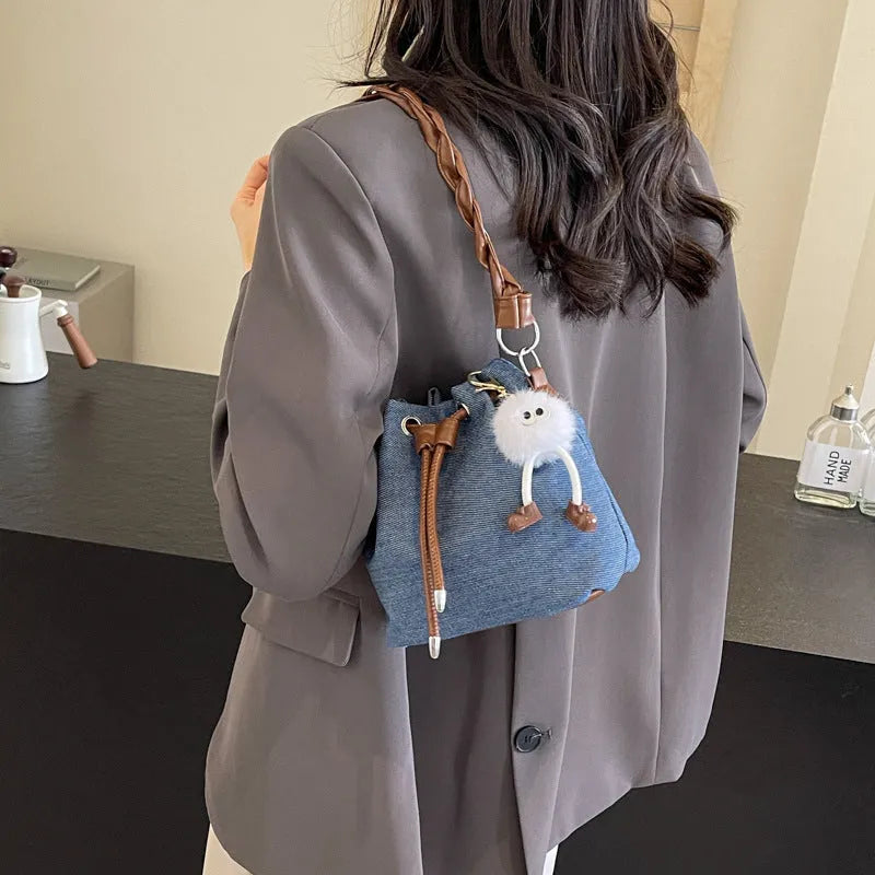 Blue synthetic leather cross body bucket bag with sandwich pocket and sling strap