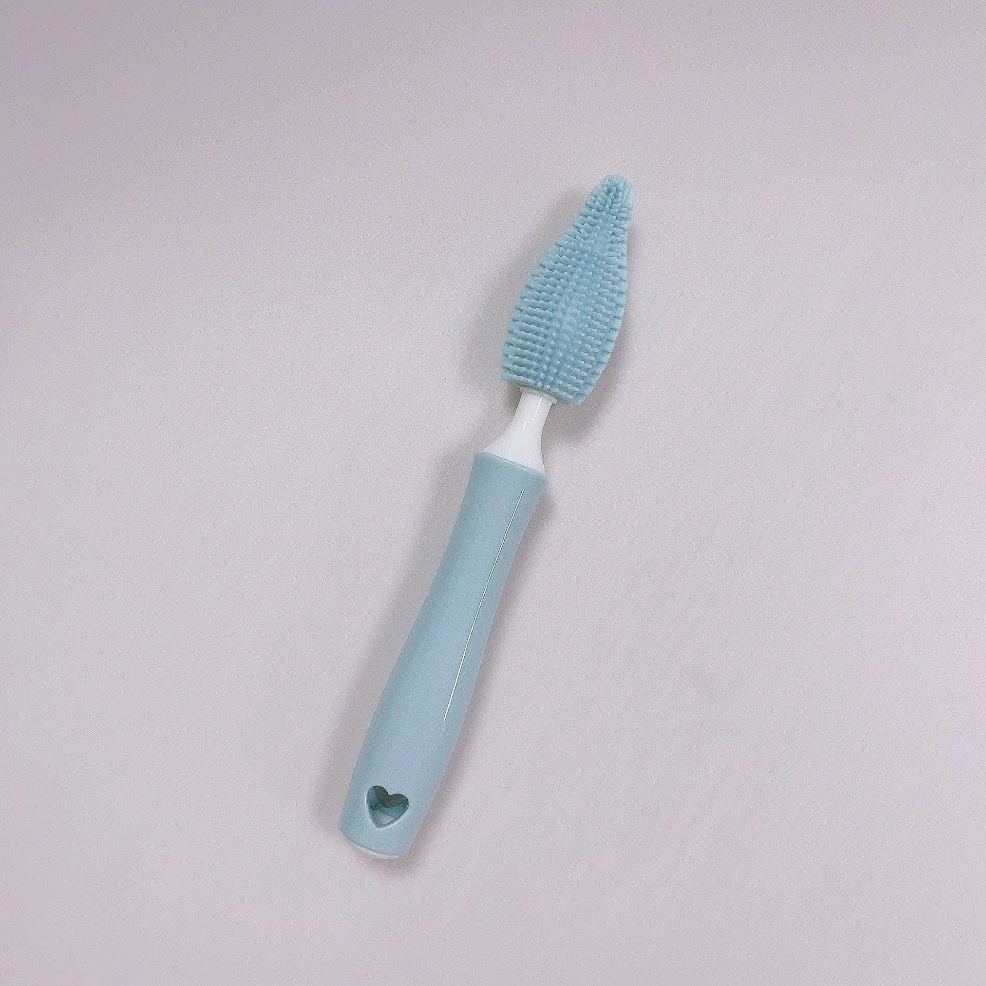 Silicone baby bottle cleaning brush and separate straw cleaner in pink, blue, and yellow colours.