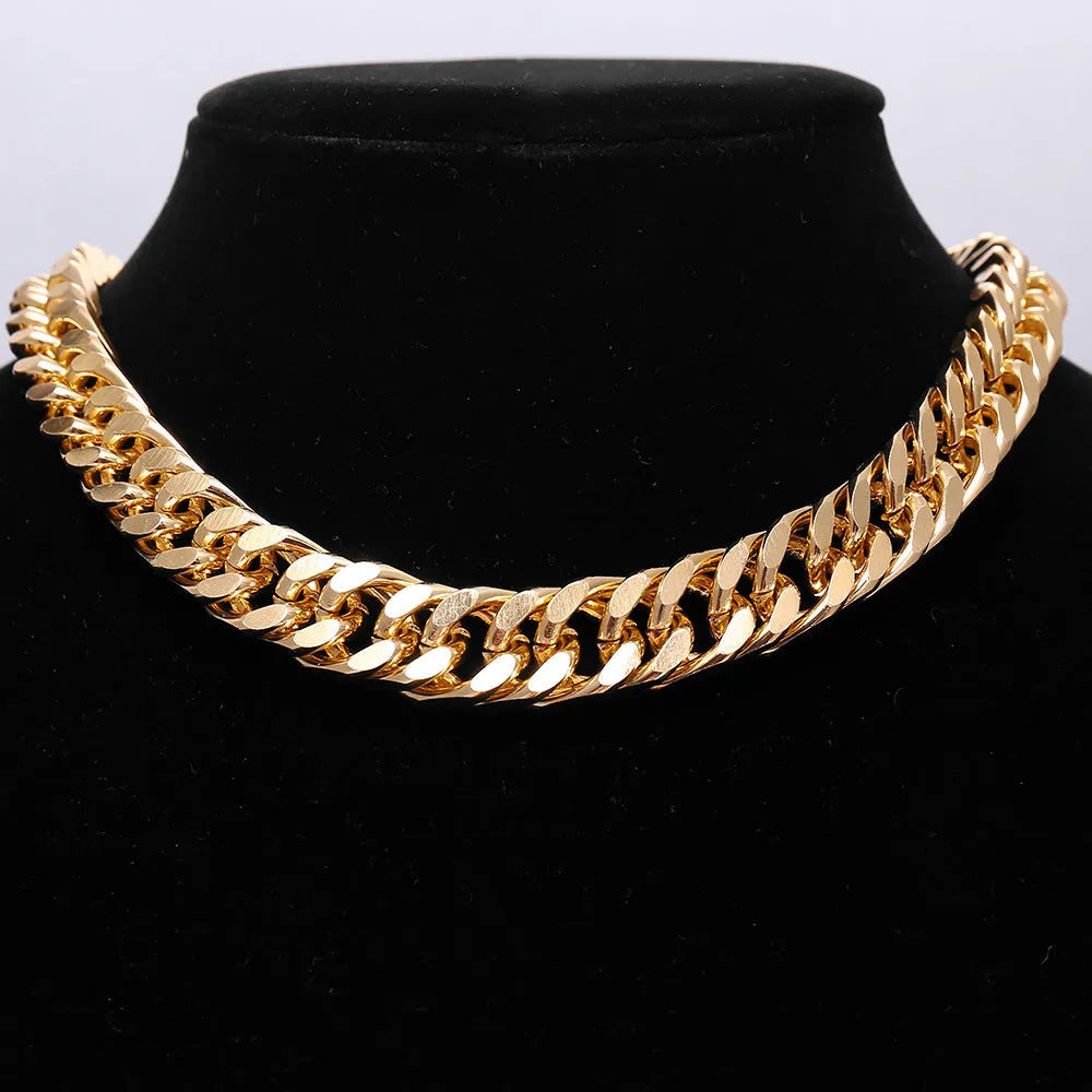 Gold coloured thick chain necklace for women on a white background.