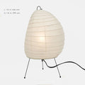 Japanese-style paper table lamp with handmade shade and aluminium base on wooden surface
