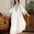 White Dubai-style Arabic robe with long sleeves and full-length skirt on hanger