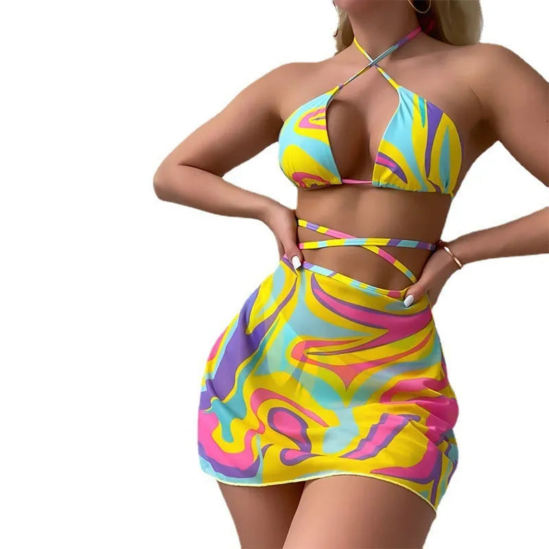 Yellow striped halter neck swimsuit with front lace-up detail, worn with matching skirt and shorts.