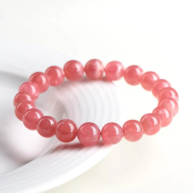 Women's crystal bracelet with red rhodochrosite stones in geometric design featuring longevity lock element