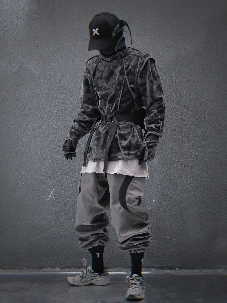 Man wearing a black and grey tie-dye print pullover sweater with loose fit and long sleeves.
